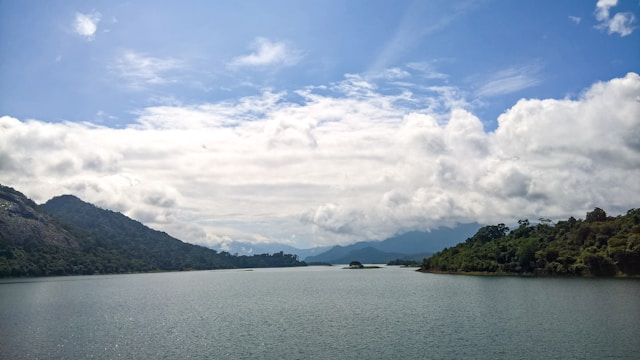  Sustainable travel: Serene Thenmala, Kerala , India : Lake with mountains in background
